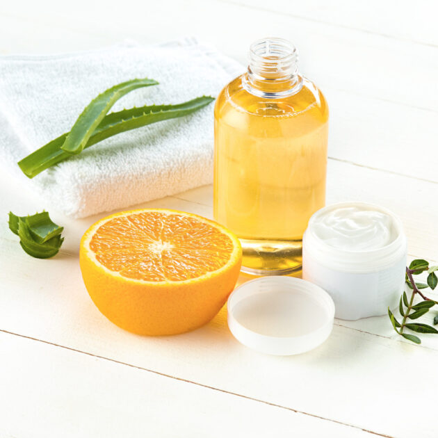 Spa concept with salt, mint, lotion, towel on white wooden background