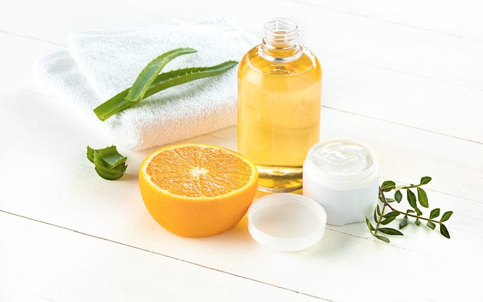 Spa concept with salt, mint, lotion, towel on white wooden background