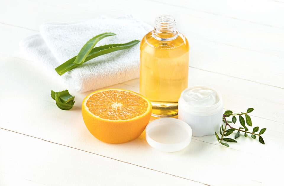 Spa concept with salt, mint, lotion, towel on white wooden background